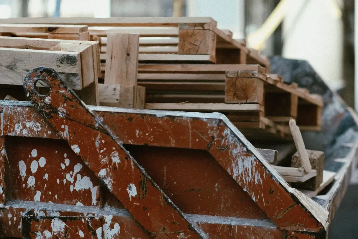 a dumpster filled with construction debris and wood pallets