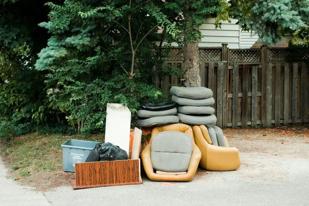 a curbside couch and dresser set out for removal