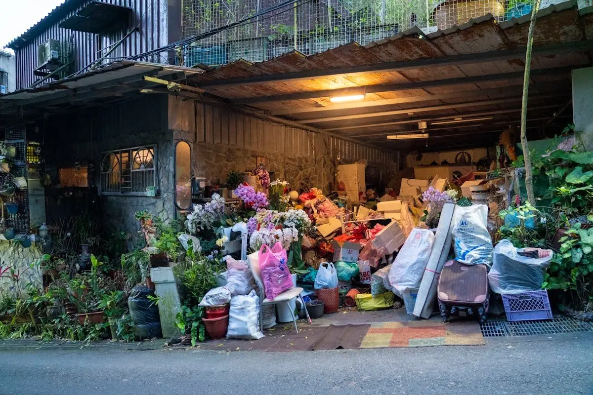 a cluttered garage full of boxes, tools, and gear
